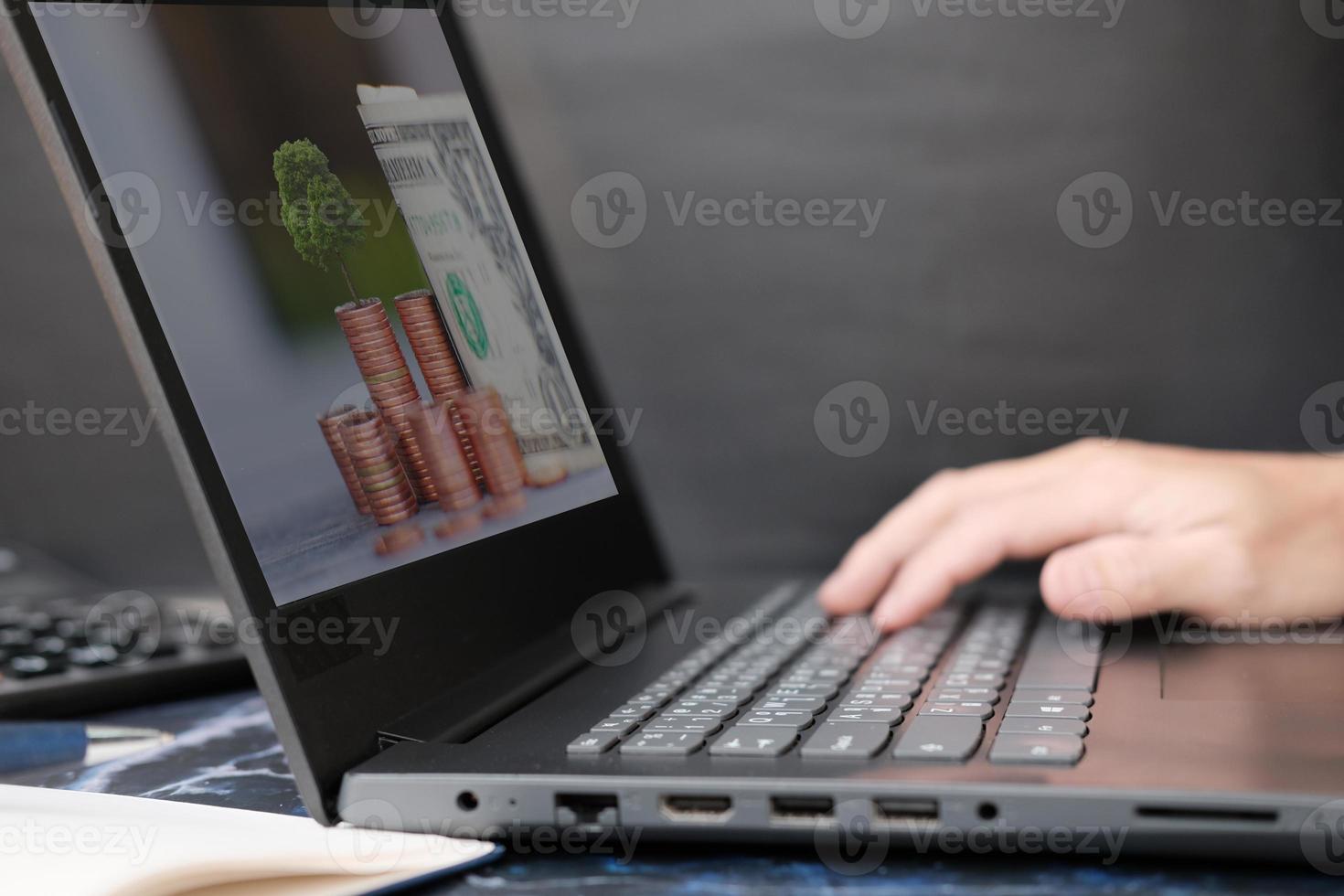 Businessman's hand working on laptop computer, technology concept photo