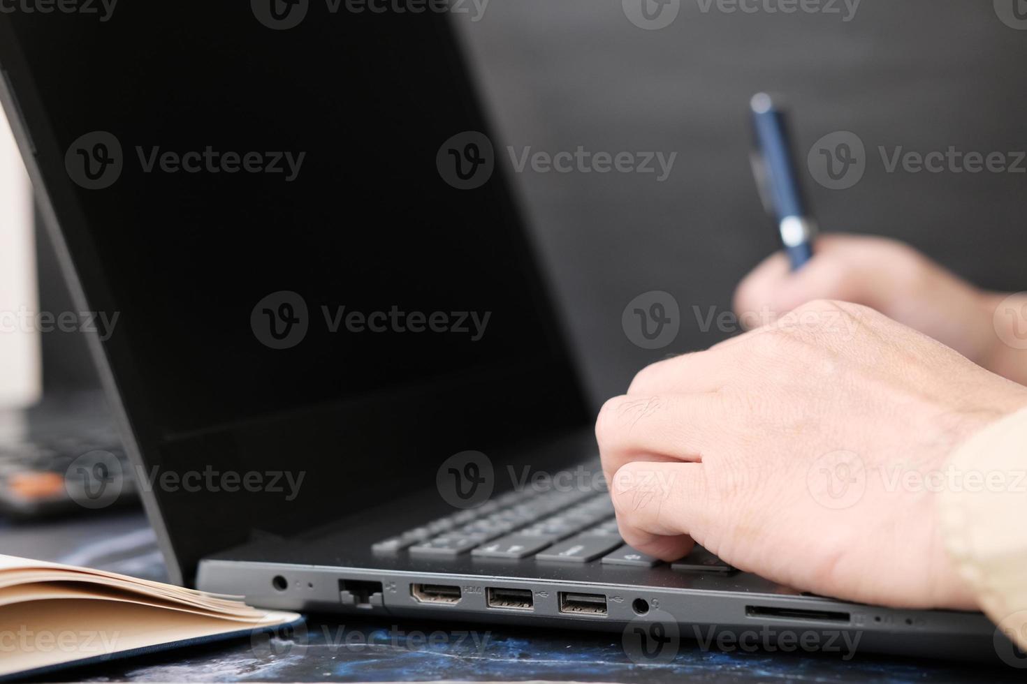 Businessman's hand working on laptop computer and technology concept photo