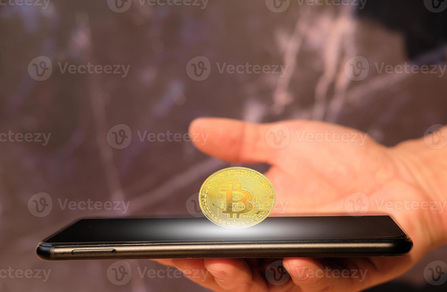Bitcoin cryptocurrency coin and euro coin on smartphone, concept photo