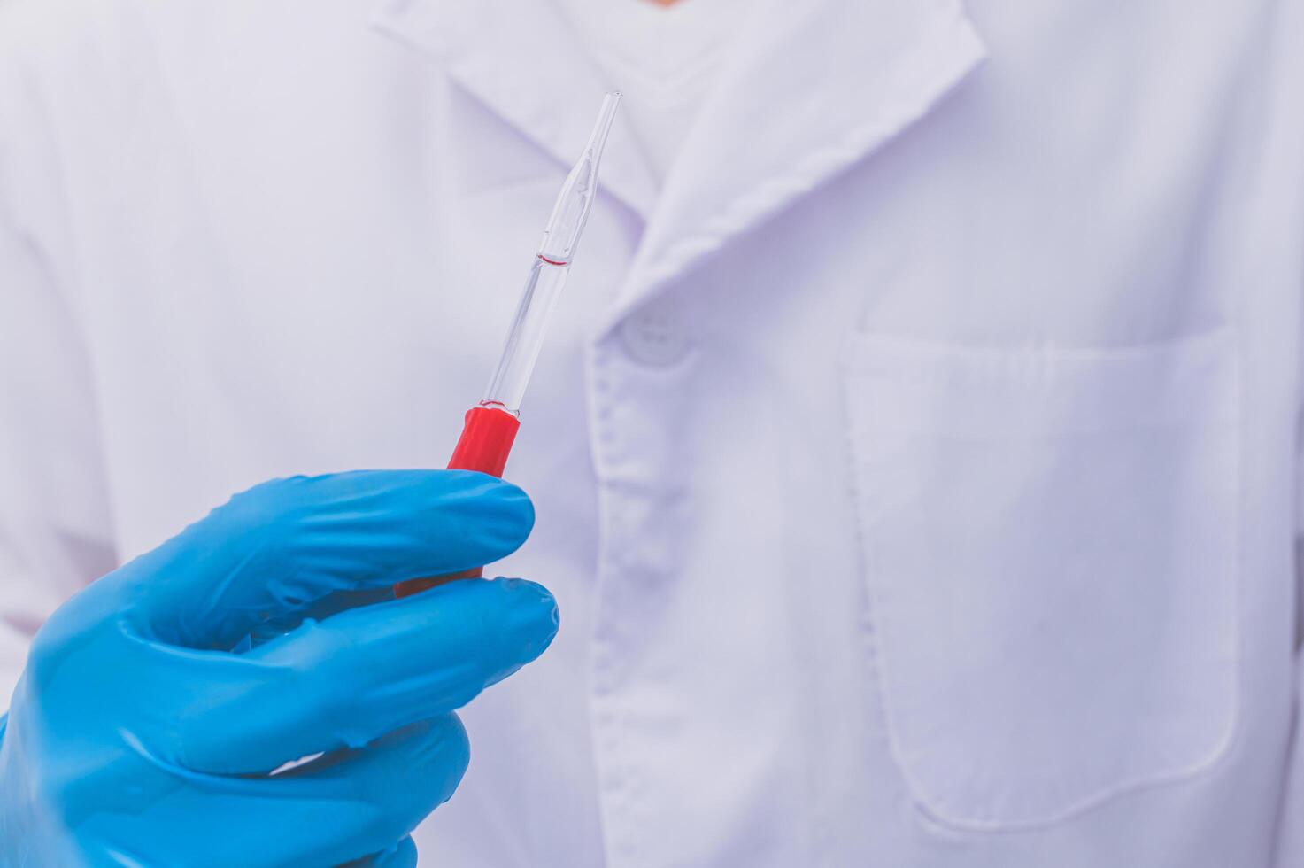 A doctor or scientist experimenting with a vaccine against diseases and illnesses photo