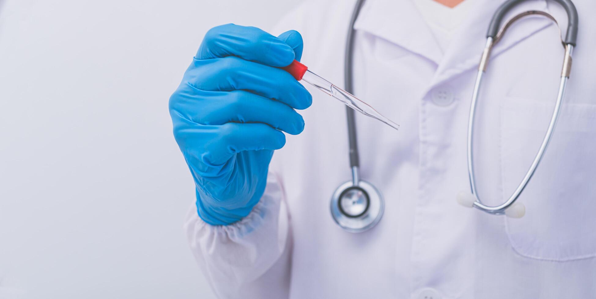 A doctor or scientist holding a vaccine to prevent diseases and illnesses photo