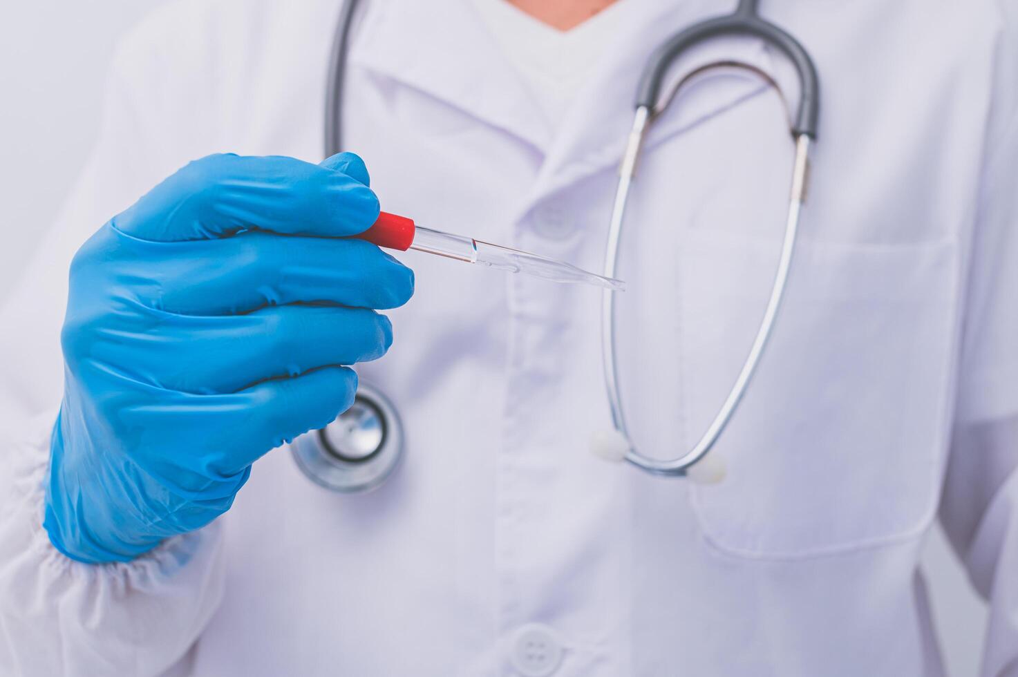 A doctor or scientist holding a vaccine to prevent diseases and illnesses photo