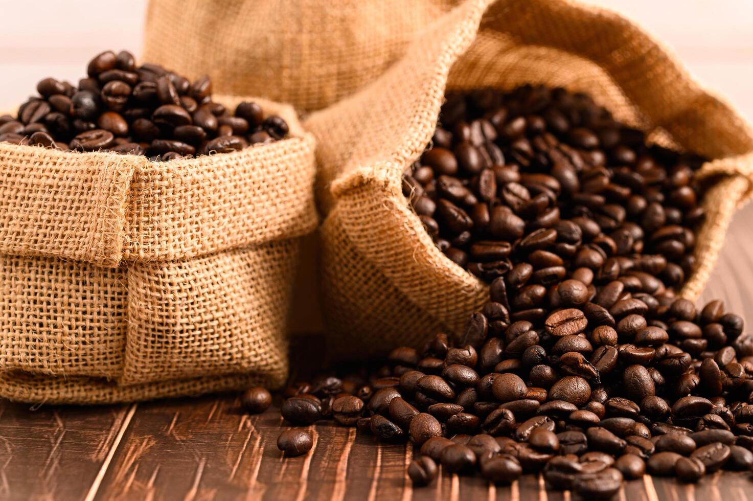 Bags of coffee beans on a wooden table photo