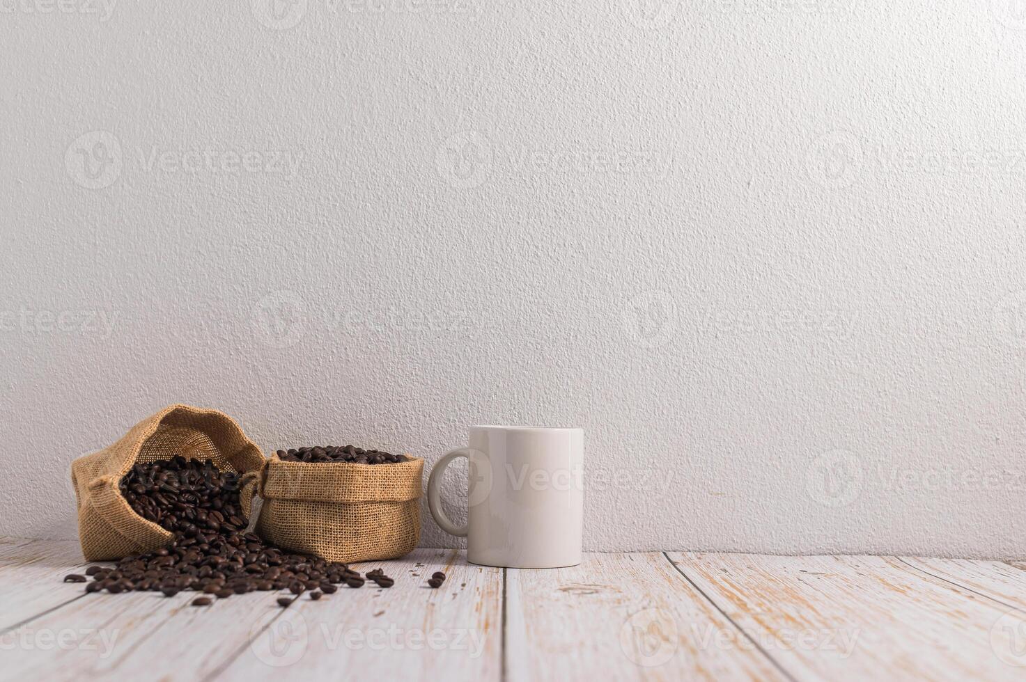 Coffee beans and coffee cup on wooden table photo