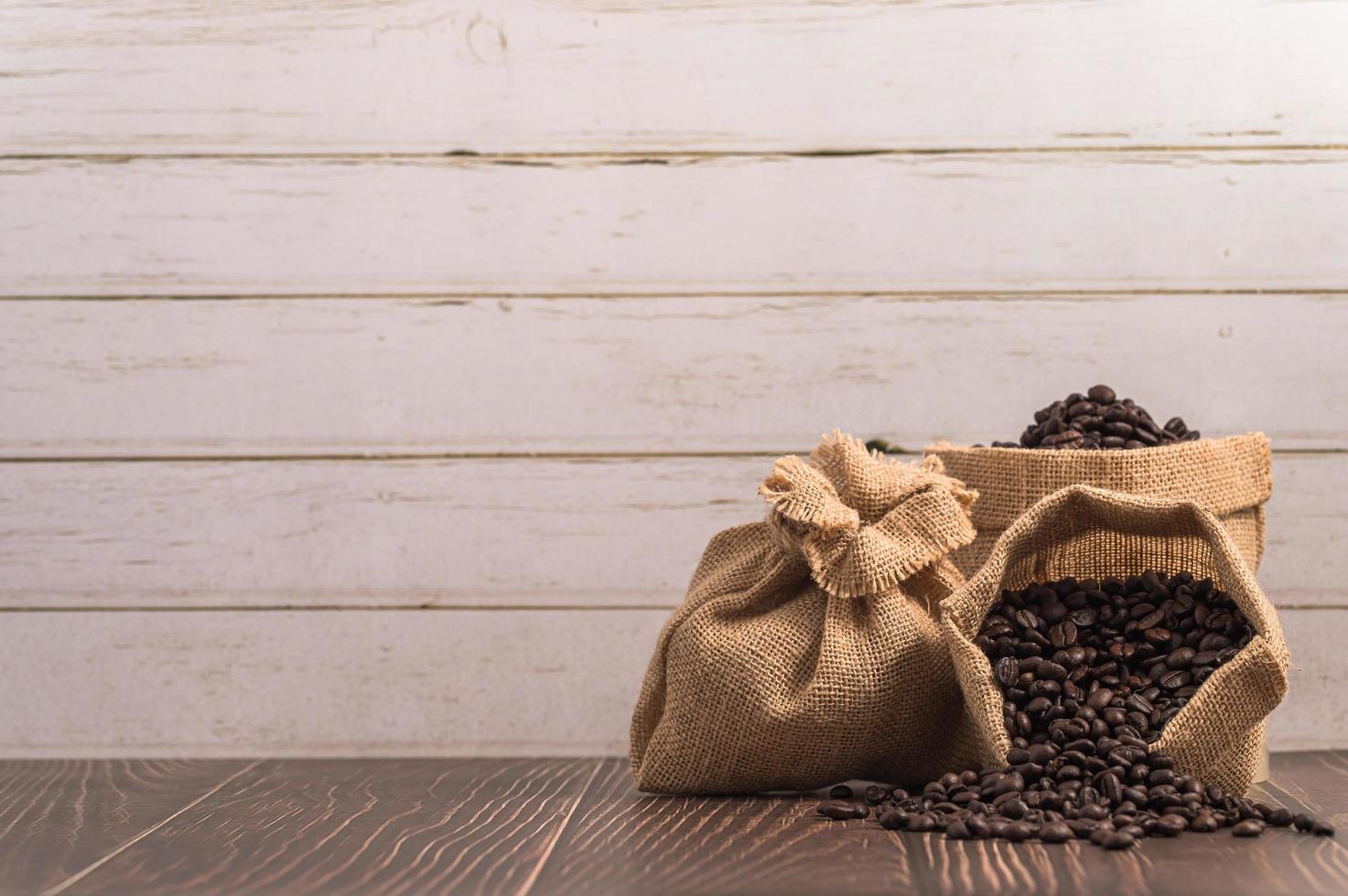 Bags of coffee beans on a wooden table photo