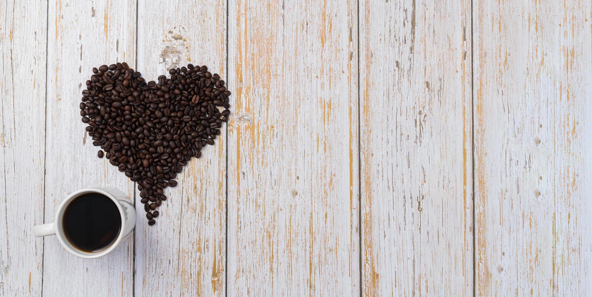 Coffee beans arranged in a heart shape, love for drinking coffee concept photo