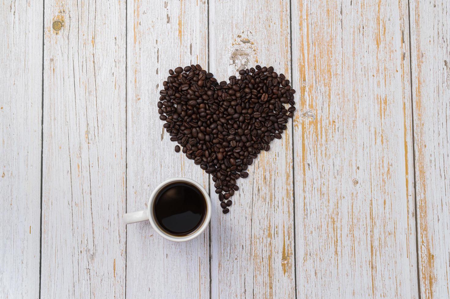 Granos de café dispuestos en forma de corazón, amor por beber café concepto foto