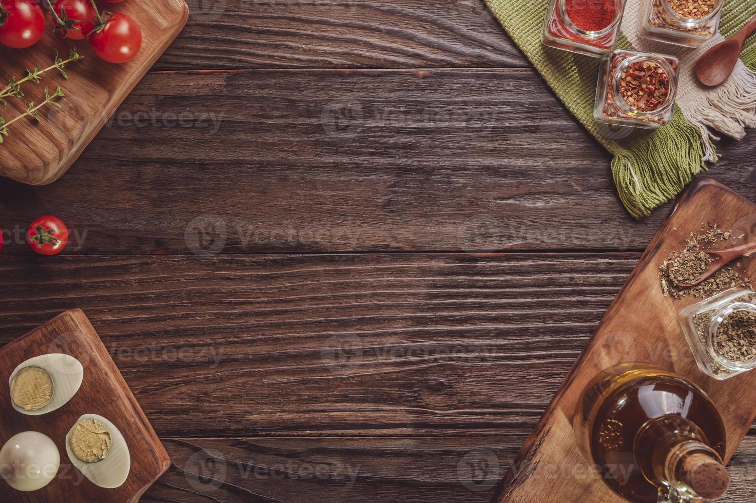 Top view of table with tomato, boiled eggs, olive oil, oregano and ingredients with space photo