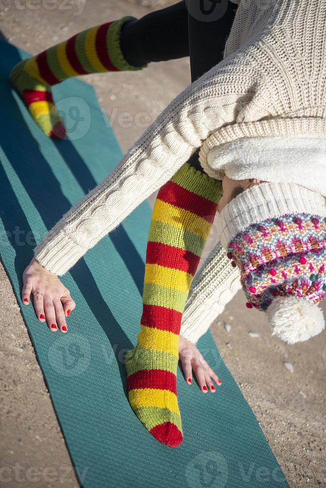 A young athletic woman performs yoga and meditation exercises outdoors photo