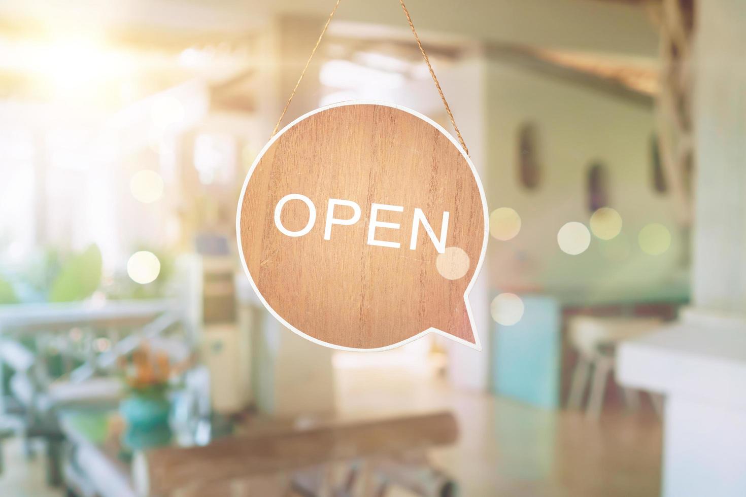 A business sign that says open on a cafe or restaurant hanging door entrance photo