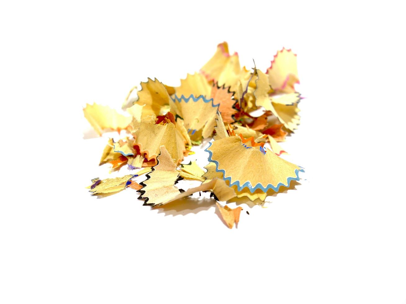 Colored pencil shavings on white background photo