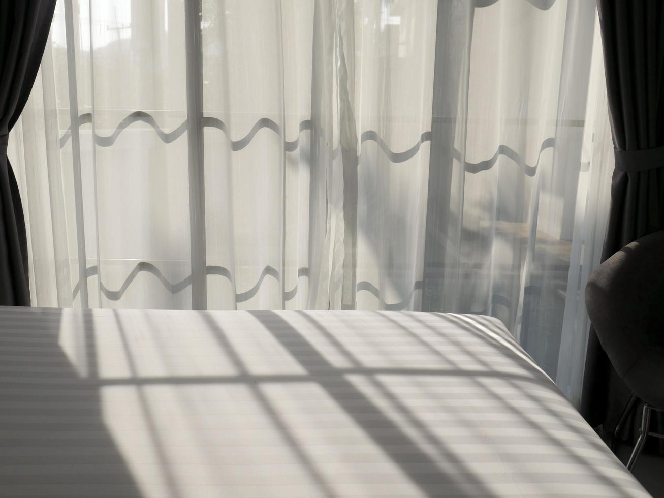 Sunlight shining through curtains in a window photo