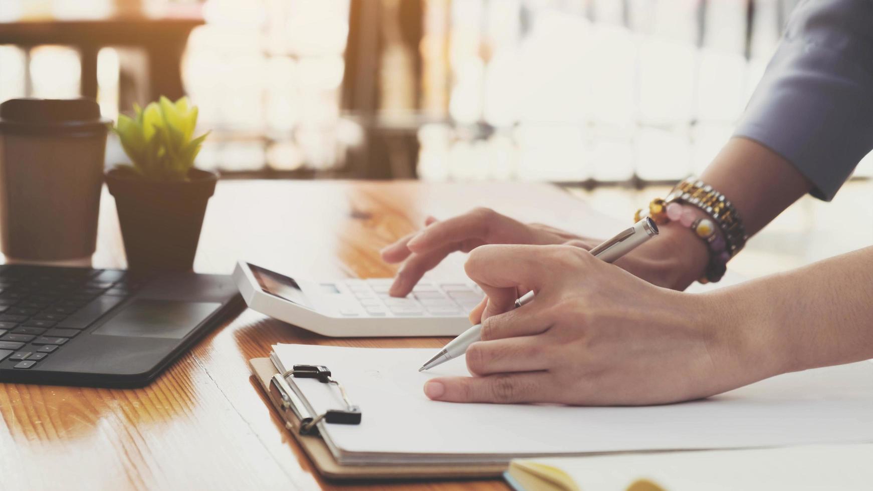 Close-up of a person making calculations photo
