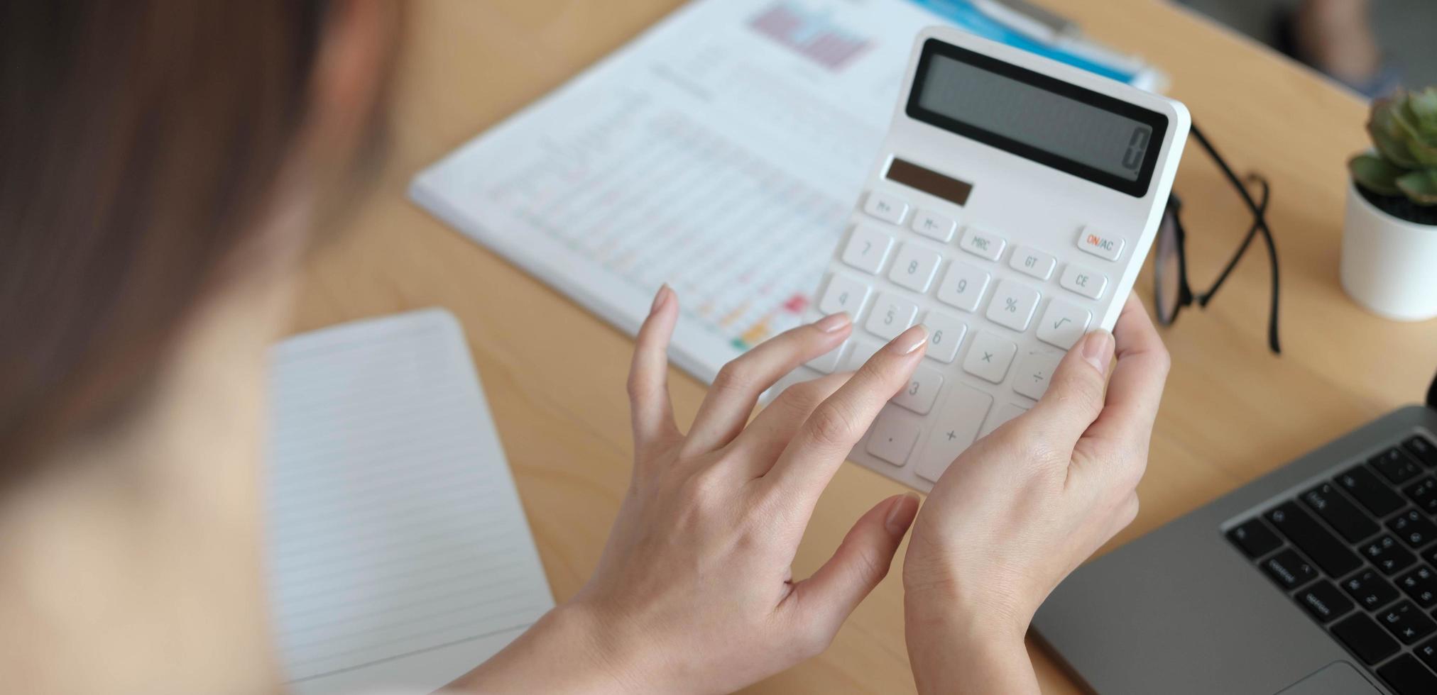 Woman using a calculator photo
