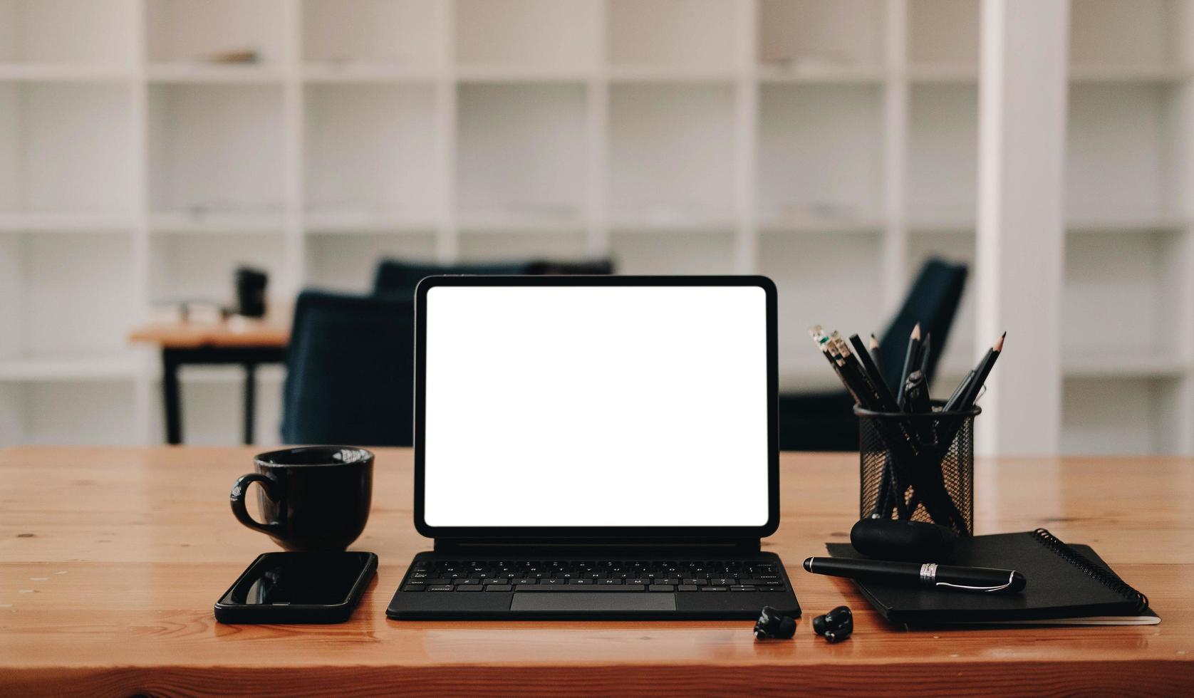 Tablet with black desk items mock-up photo