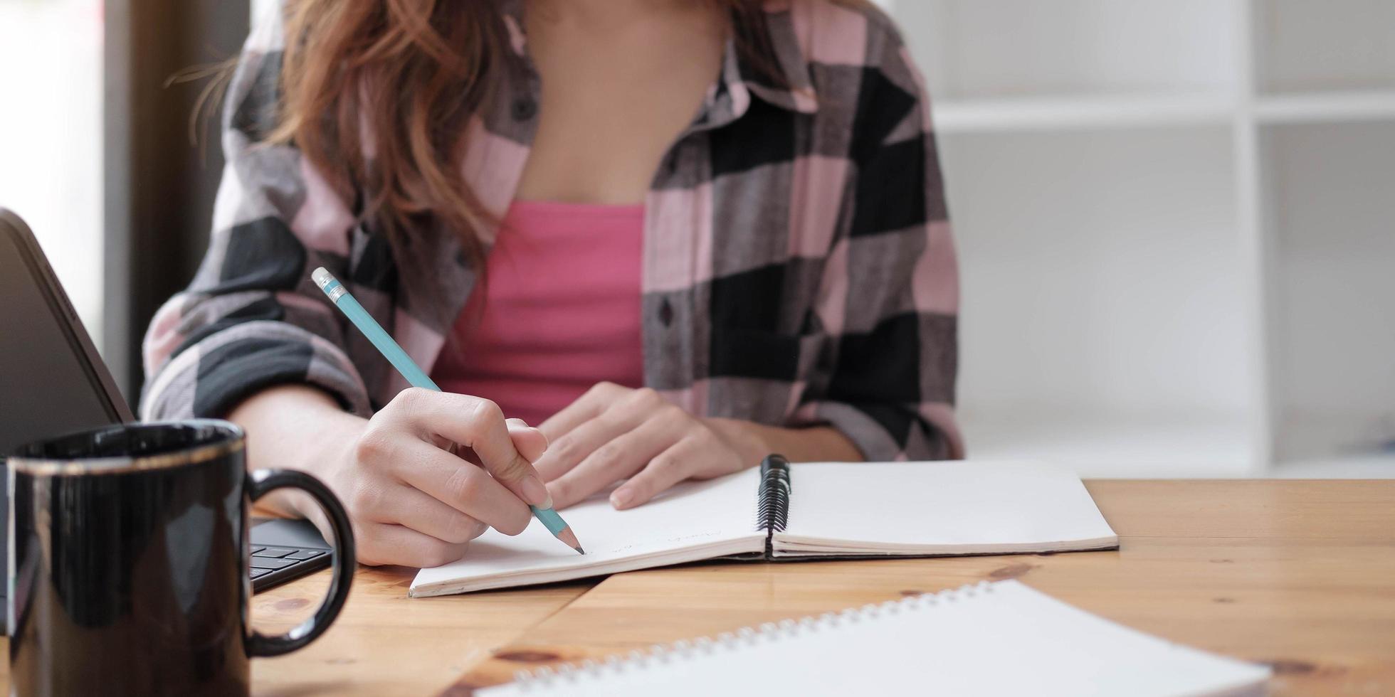 Woman writing in a notebook photo