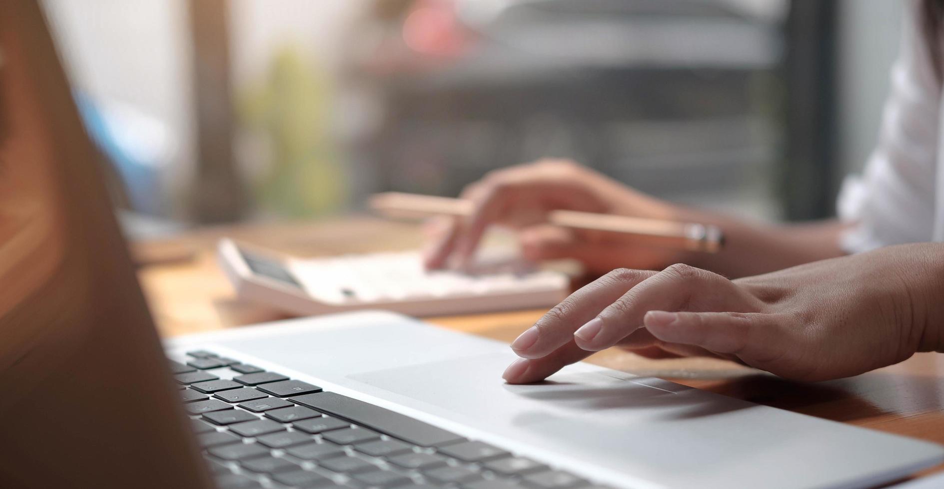 Close-up of hands on a trackpad photo