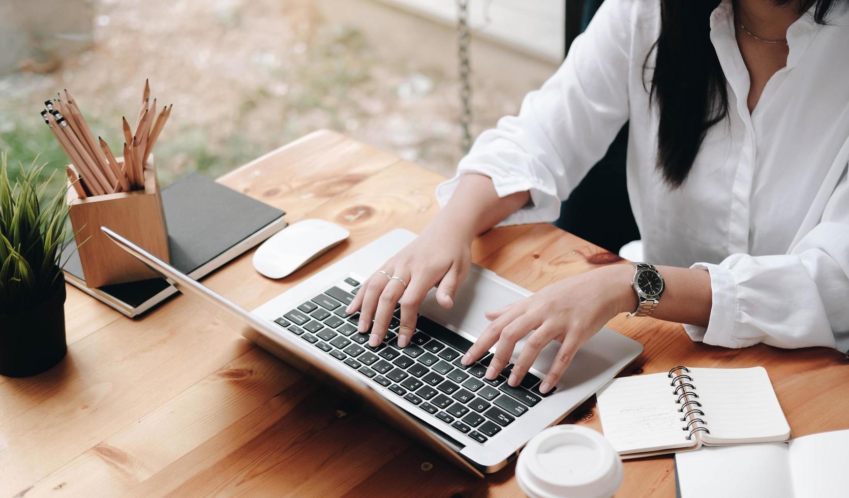 Close-up of a woman working at a desk photo