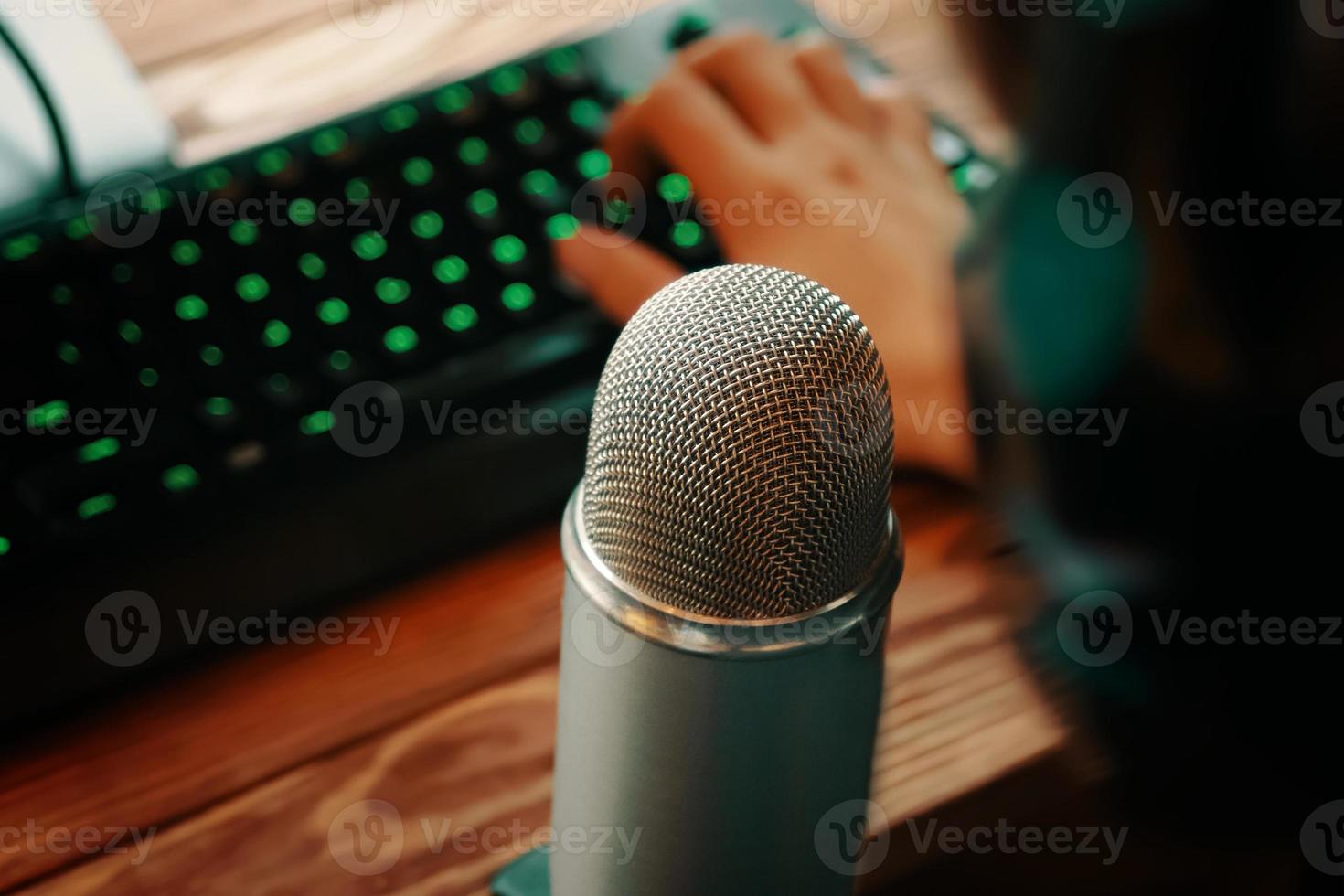 Podcast studio microphone with keyboard photo