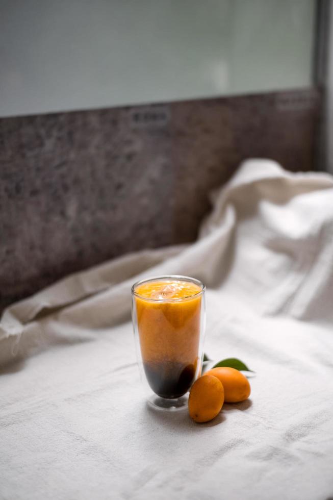 Marian plum smoothie with espresso shots on cloth photo