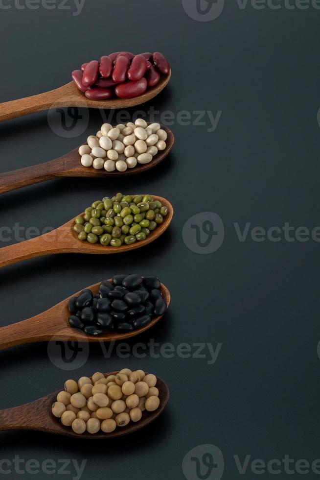 Collection of whole grains seeds isolated on black background photo