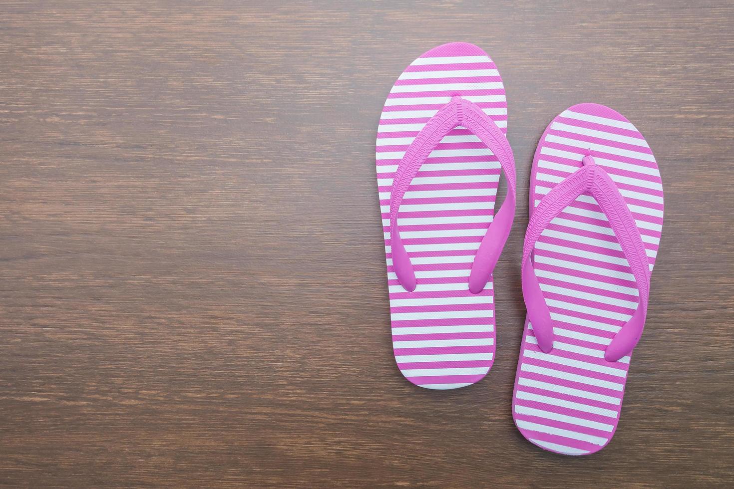 Flip flop on wooden background photo