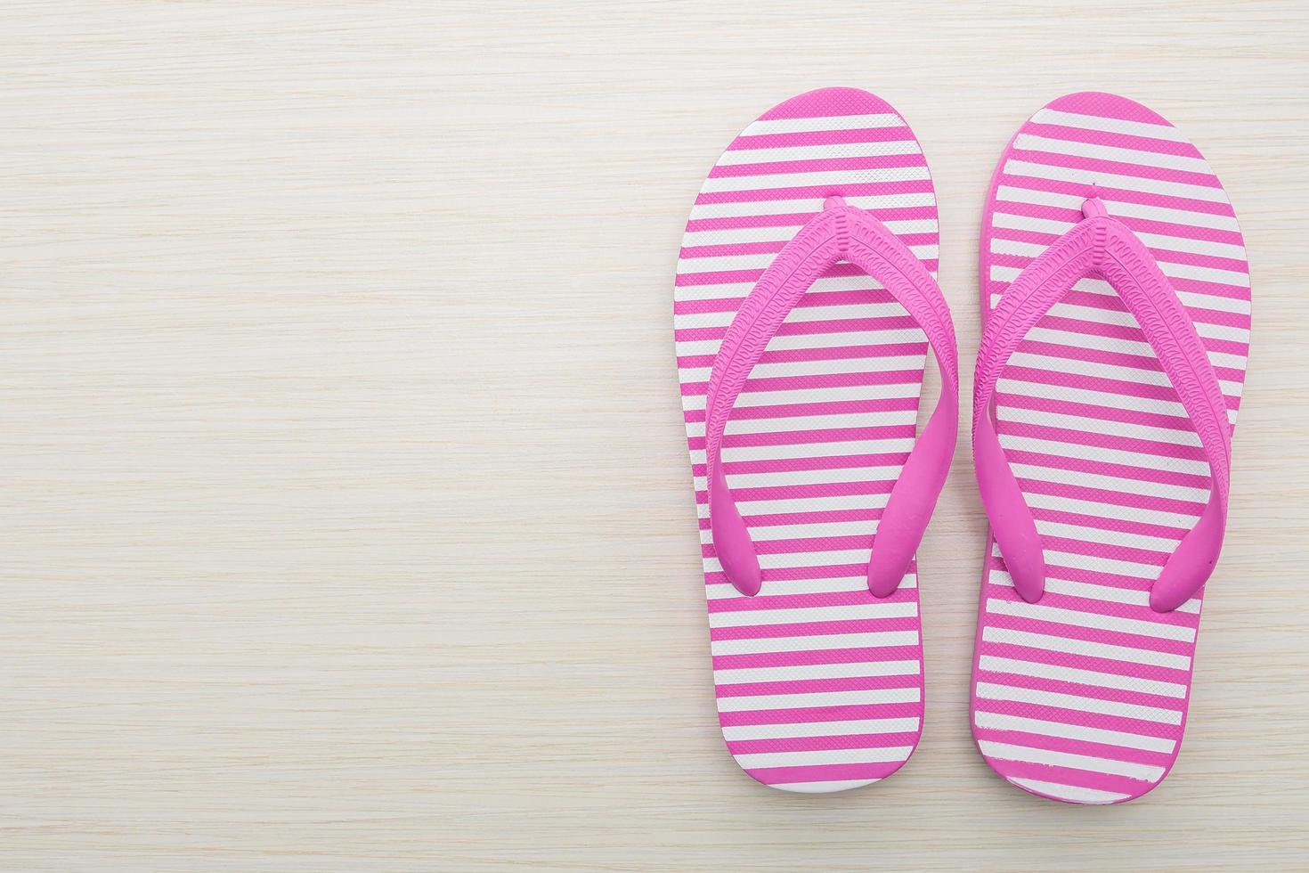 Flip flop on wooden background photo