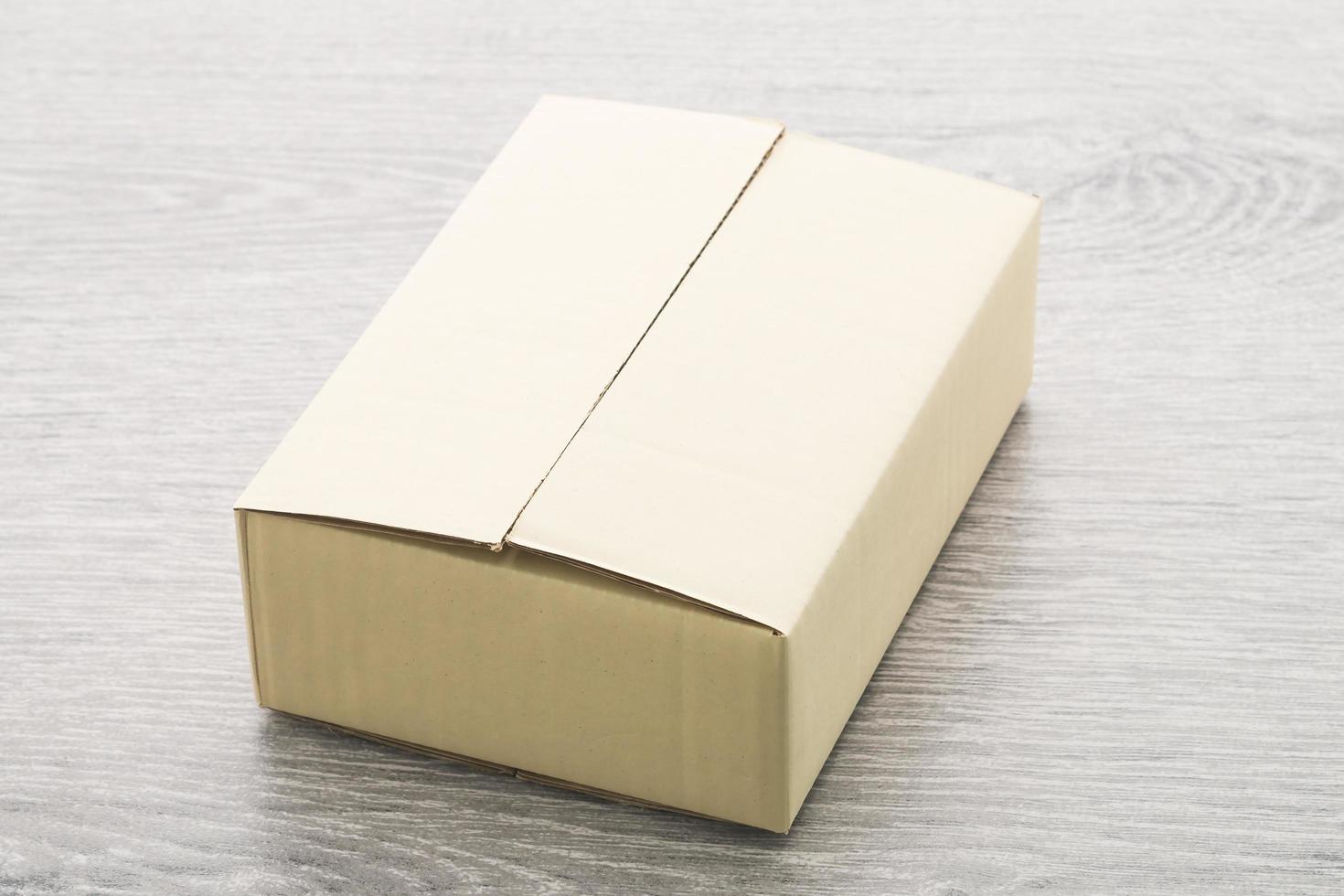 Paper box on wood background photo