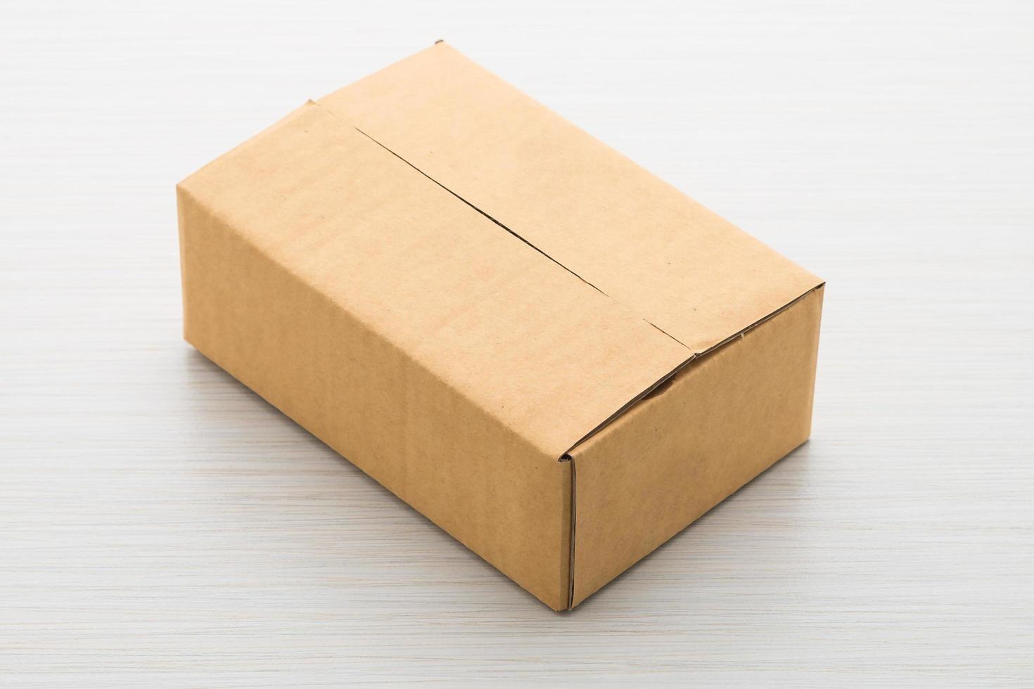 Paper box on wood background photo