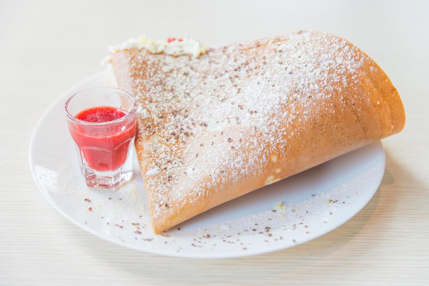 Crepe dessert with strawberry fruit and whipping cream photo