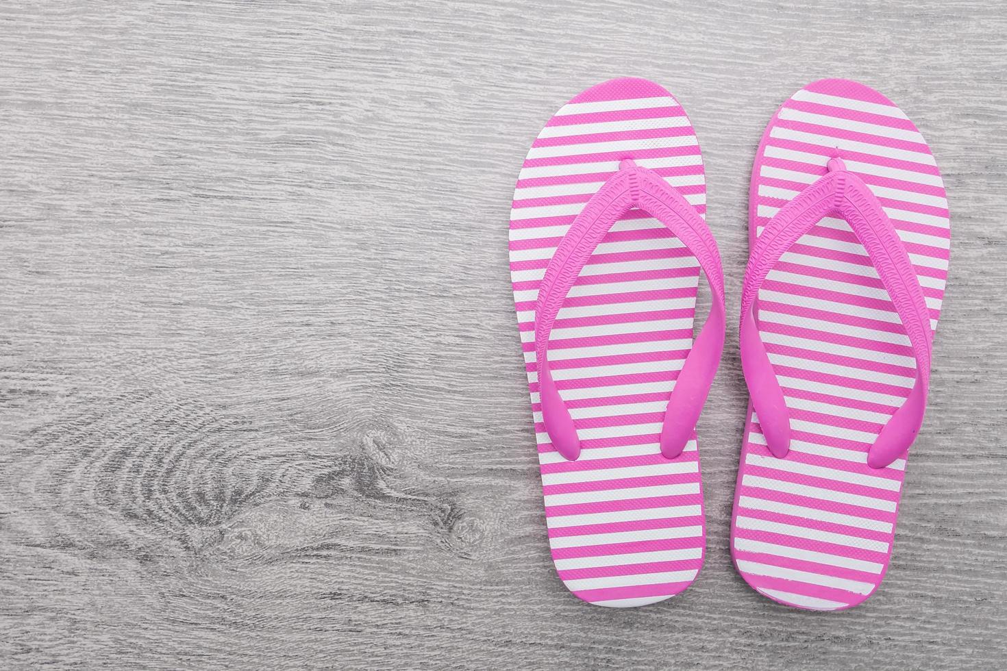 Flip flop on wooden background photo