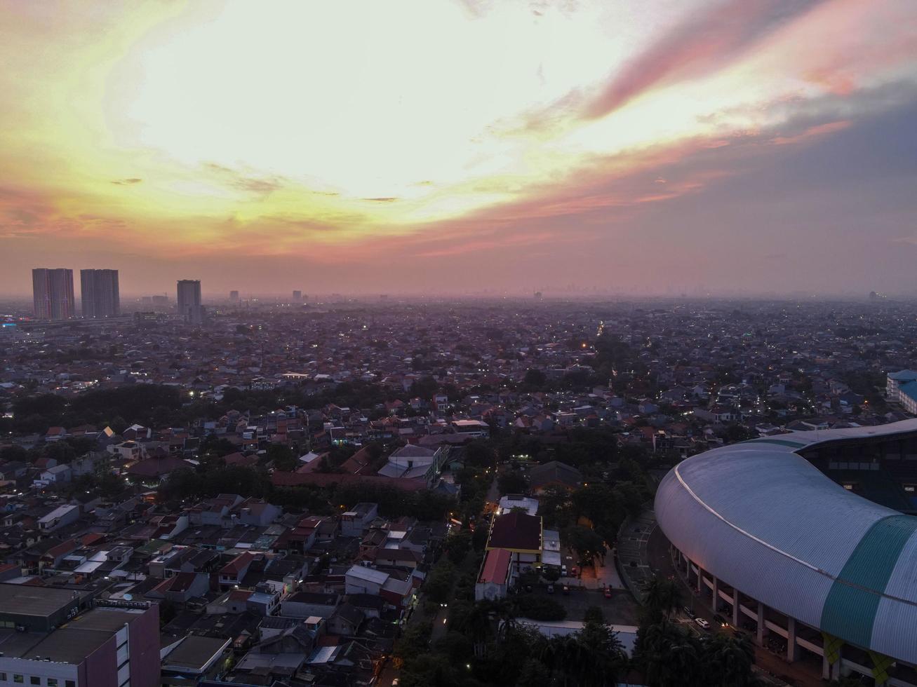 Bekasi, Indonesia 2021- Aerial view of the largest stadium of Bekasi from a drone with sunset and clouds photo