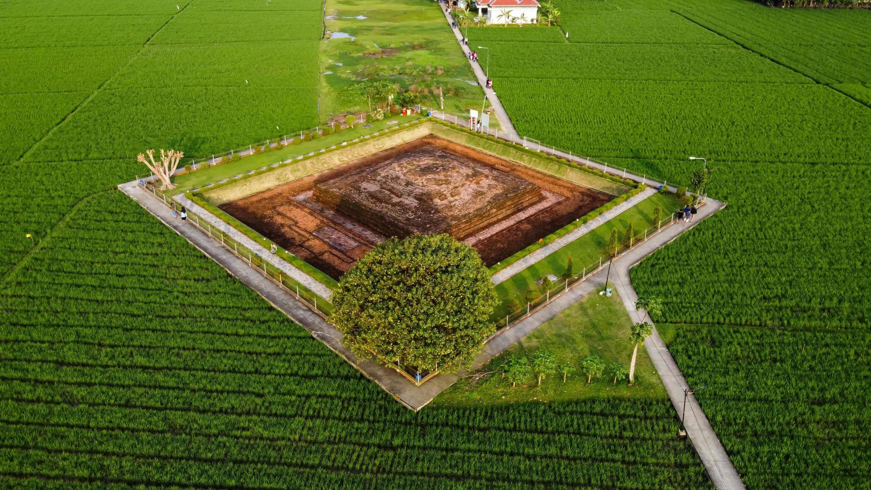 Karawang, Indonesia 2021- Aerial drone view of Blandongan Temple at Karawang and surrounded by green grass photo