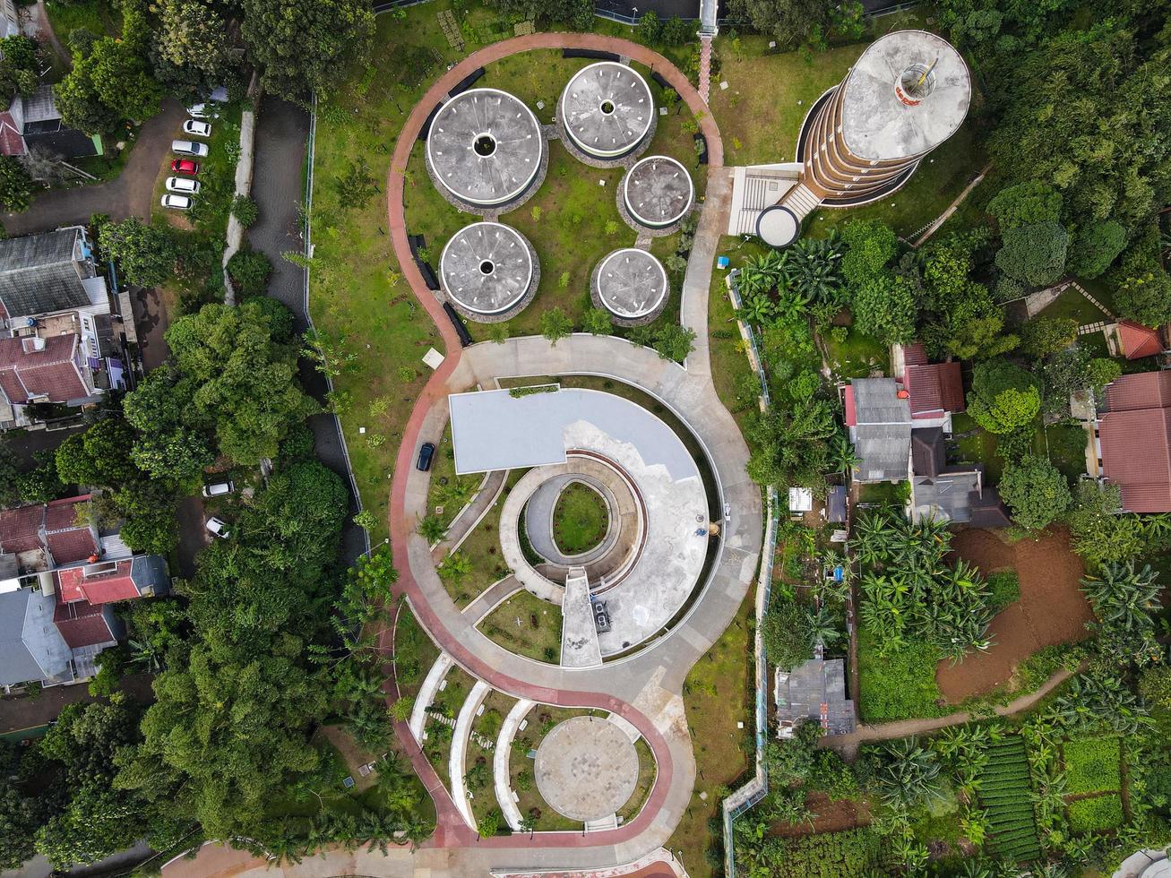 Depok, Indonesia 2021- Aerial view of playground yard in public park surrounded by green trees photo