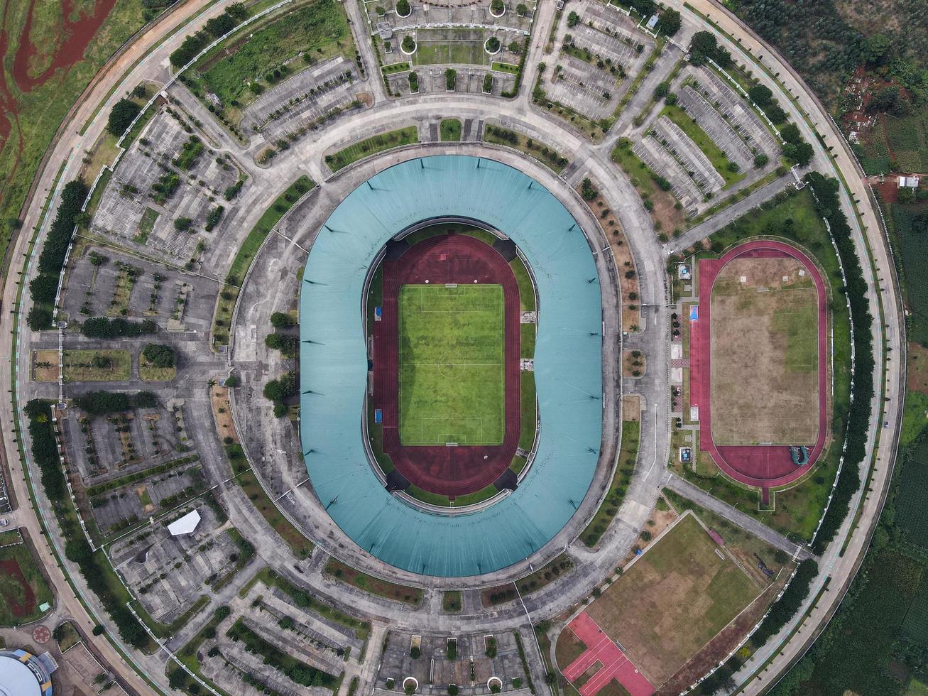 Bogor, Indonesia 2021- Aerial view of the largest stadium Pakansari Stadium from drone with clouds and sunset photo