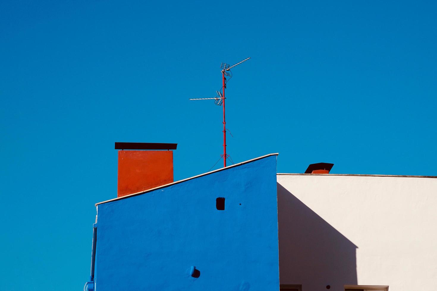 Antenna tv on the rooftop of a house photo