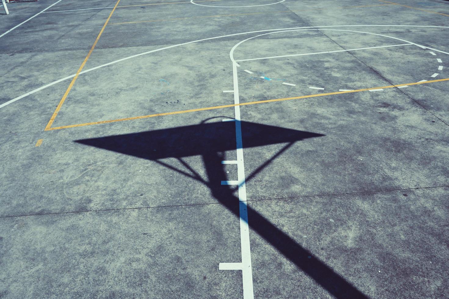 Street basketball hoop shadow silhouette on the court photo