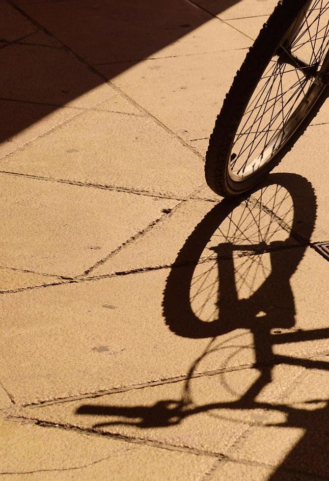 Bicycle shadow silhouette wheel on the street photo
