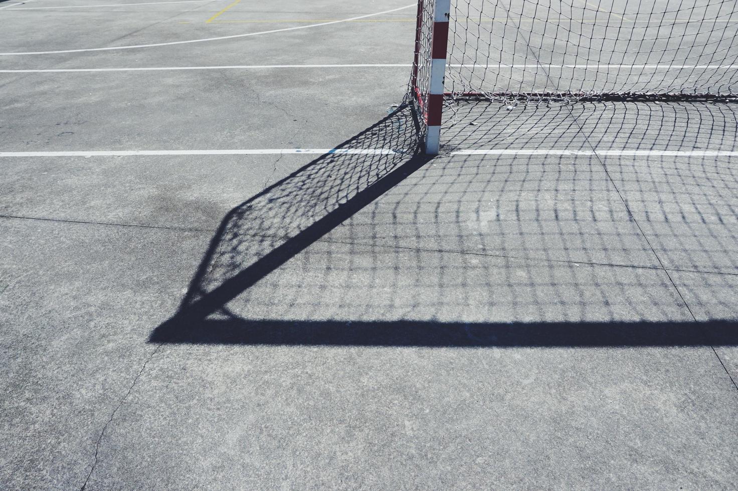 Street soccer goal shadow on the field photo