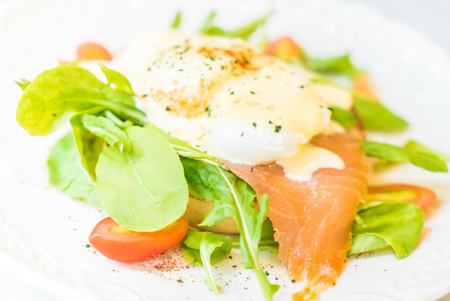 Poached eggs with salmon and rocket salad photo