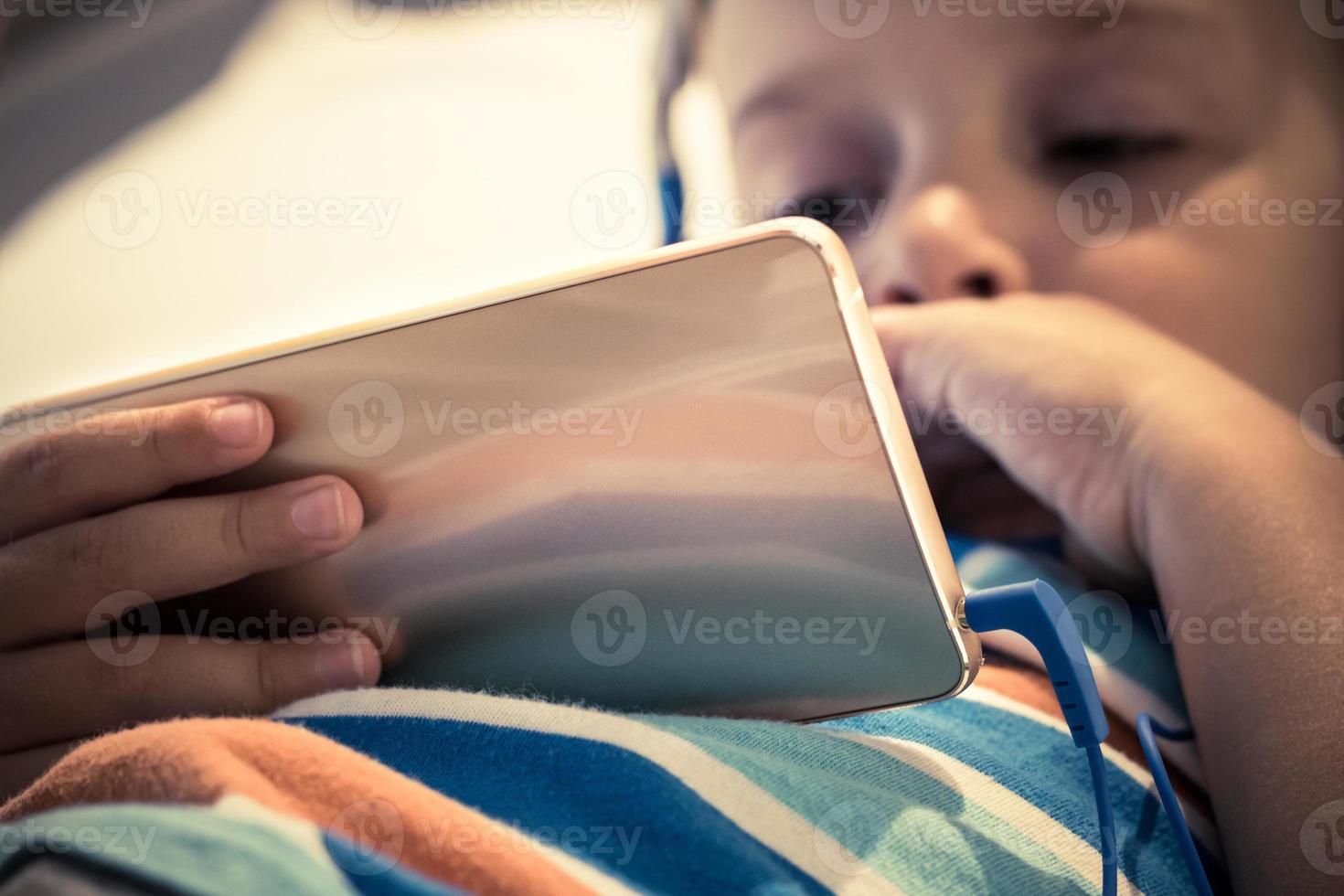 Close-up of child using smartphone photo