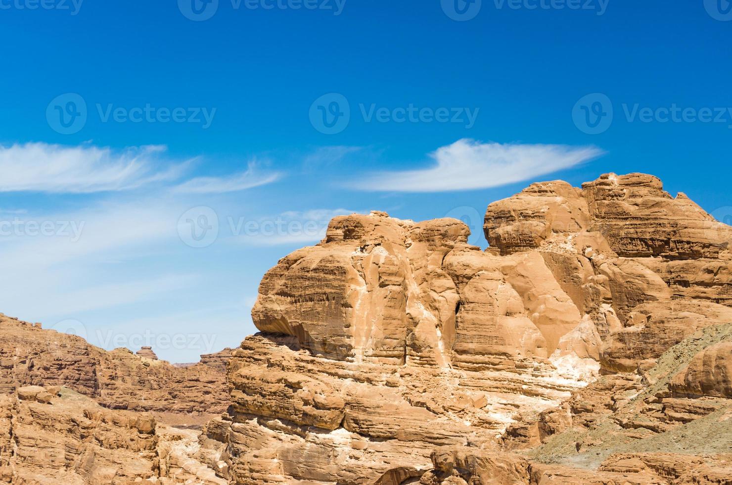 Light brown rock formations and blue sky photo