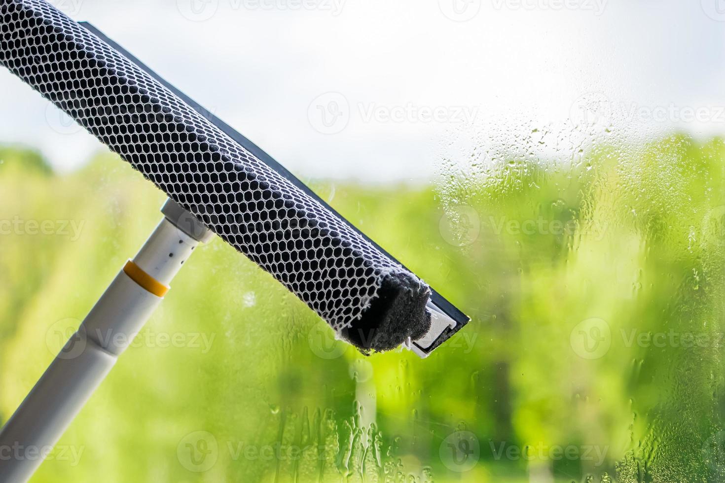 Close up of a squeegee window washing photo