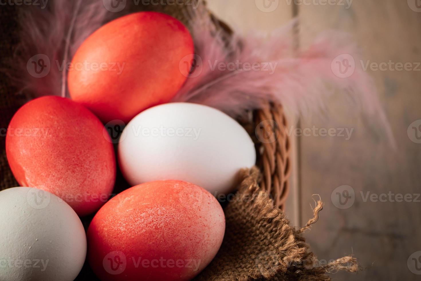 White and orange easter eggs on a wooden background photo