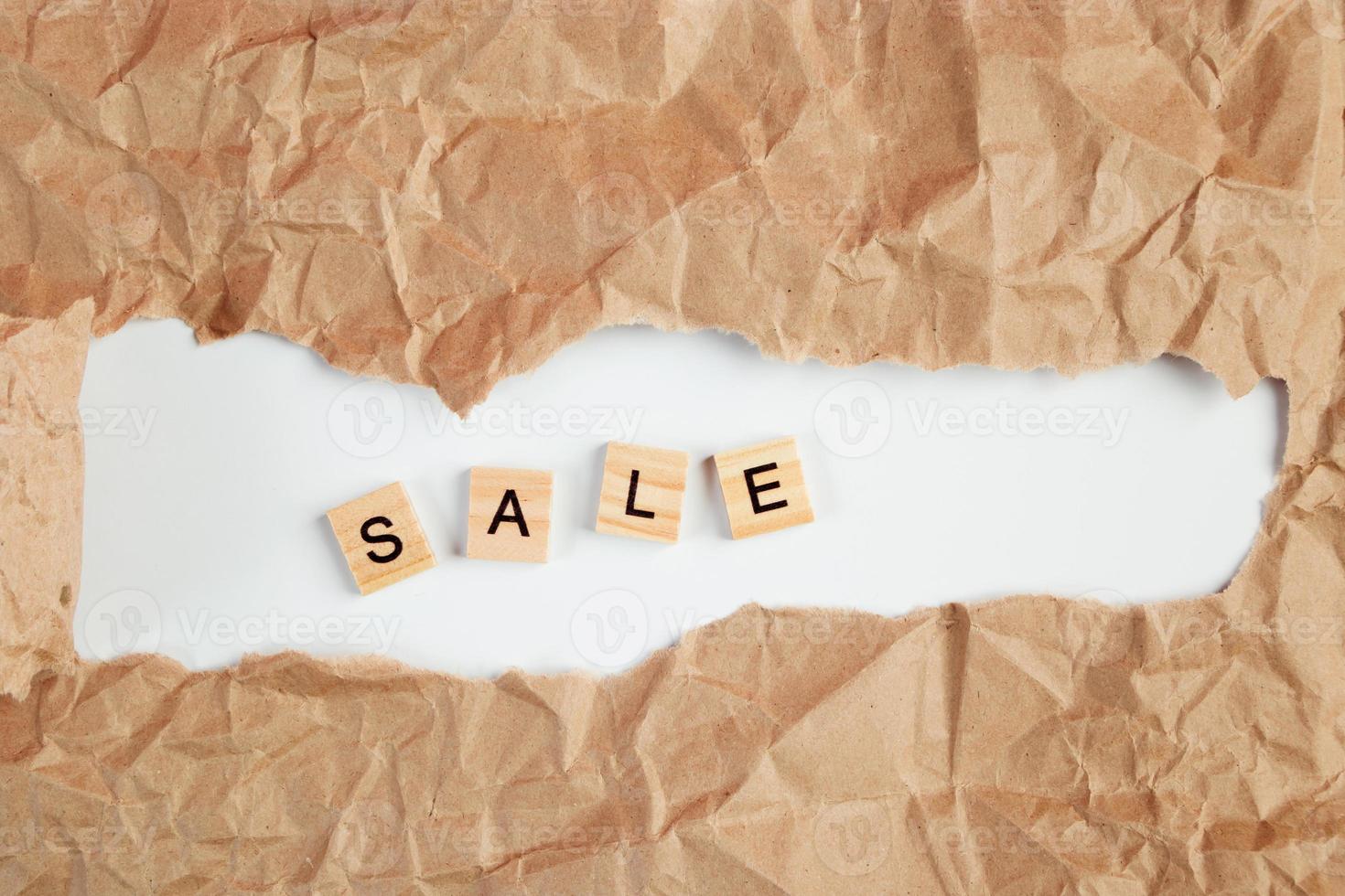 Black Friday sale text in torn craft paper photo