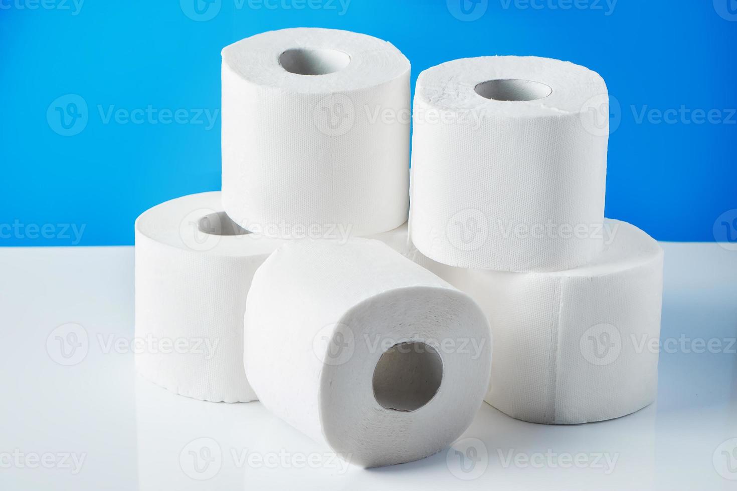 Rolls of toilet paper on a blue background photo