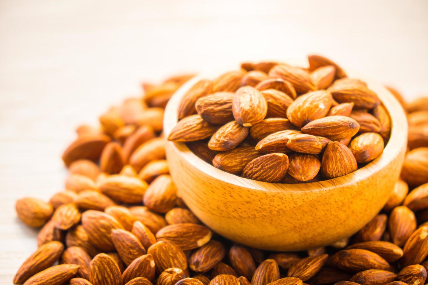 Almonds nut in wooden bowl photo