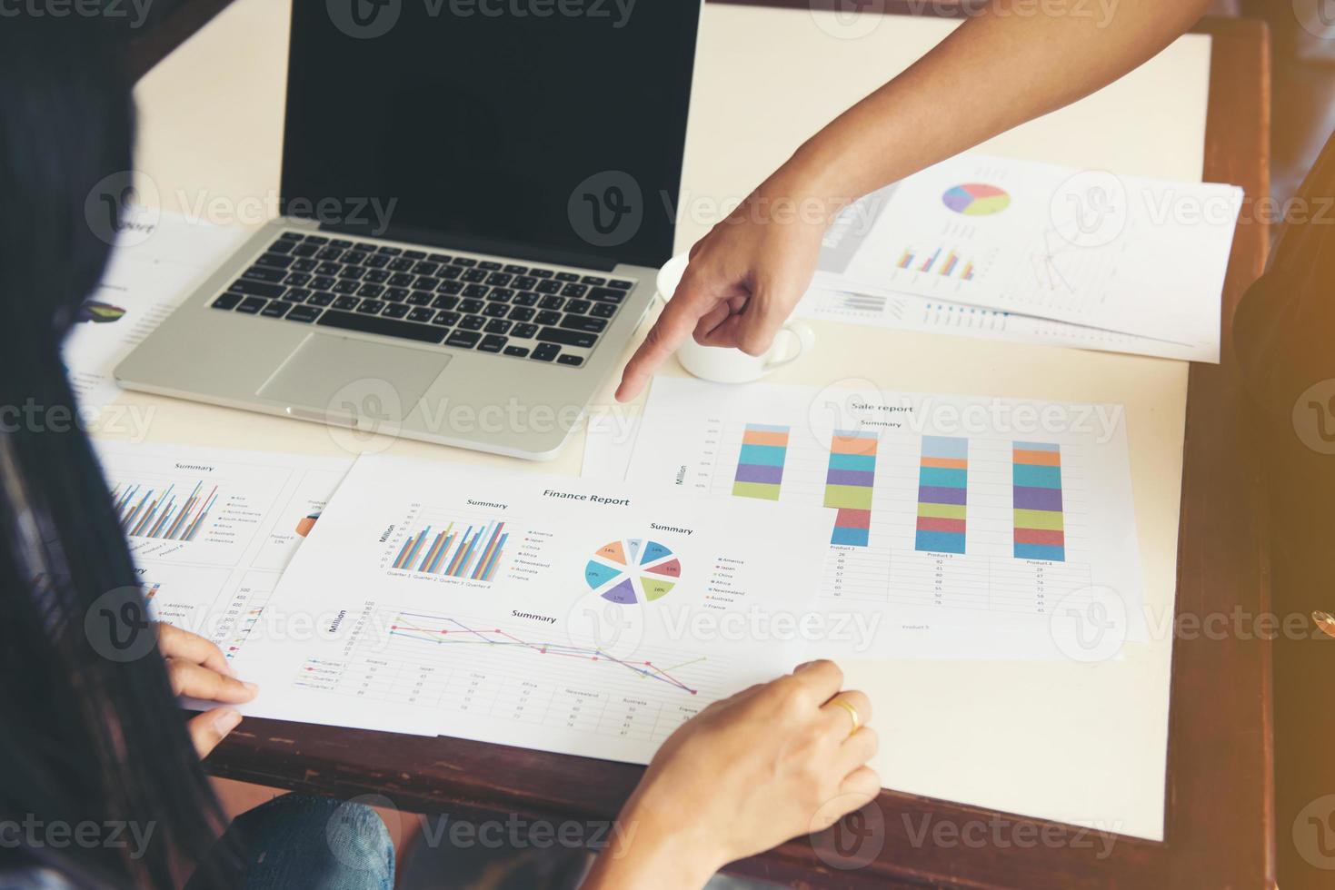 Hand pointing at a chart during a business meeting photo