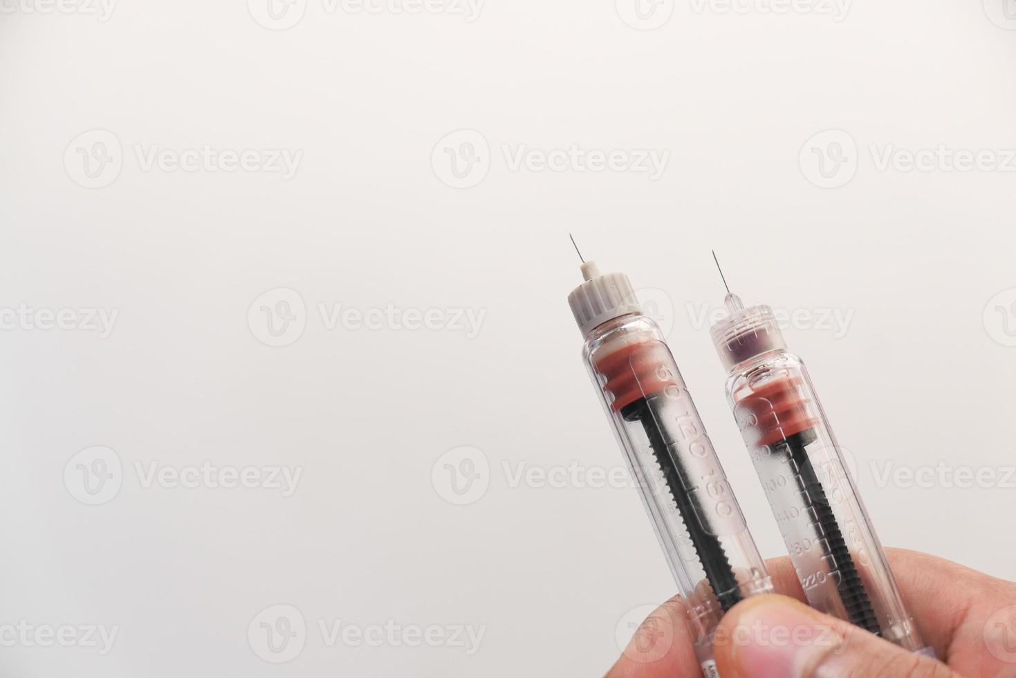 Two insulin pens on neutral background photo