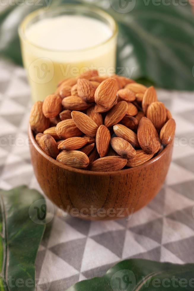 Almonds in a bowl on table photo